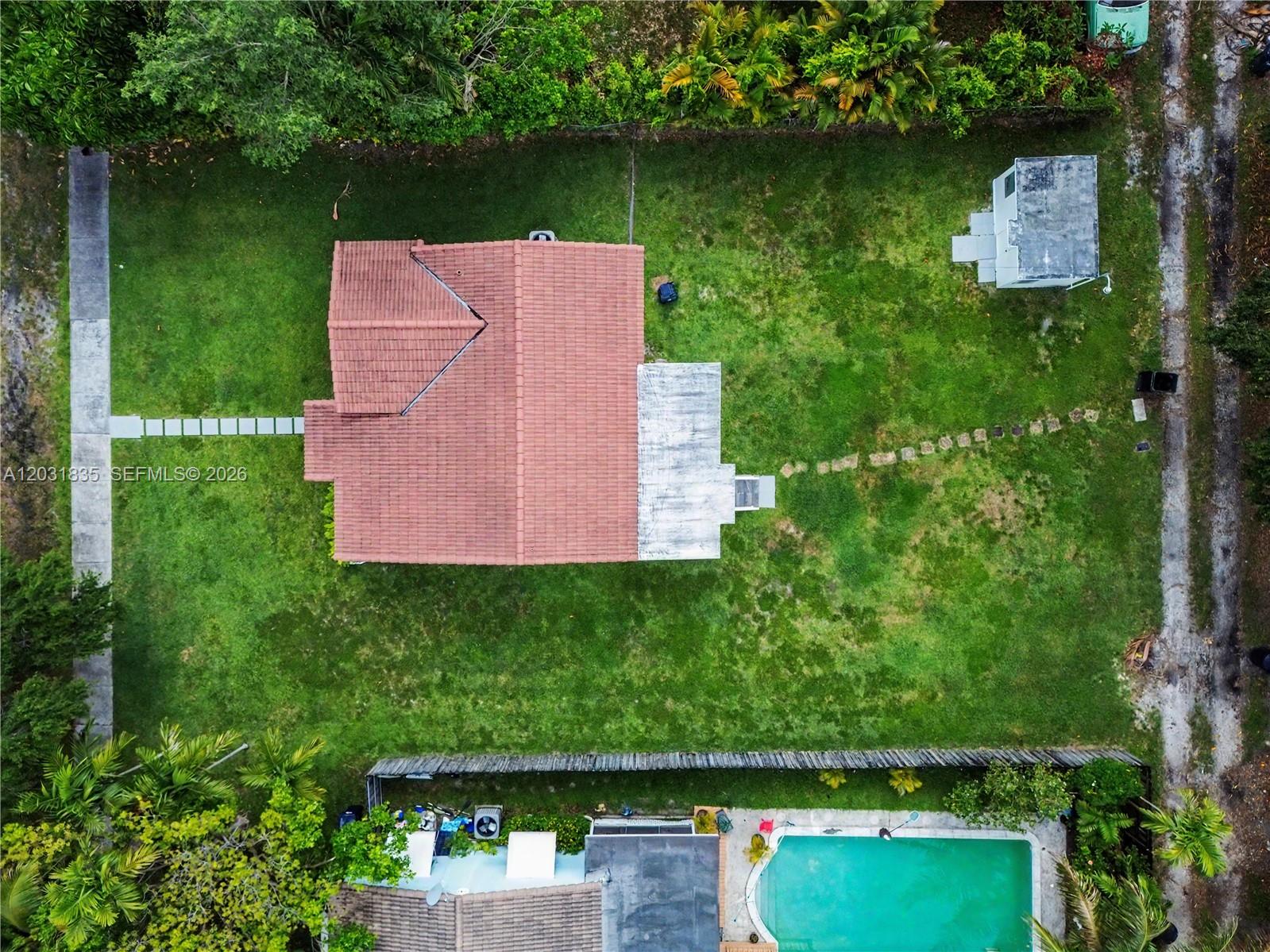 An aerial view shows a house with a red tile roof and a detached shed — 436 Lark Ave, Miami Springs FL 33166, MIAMI SPRINGS, FL