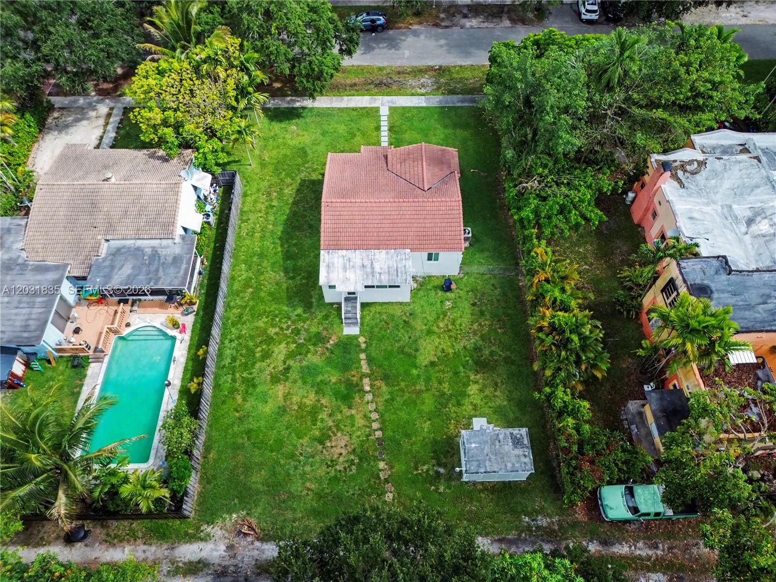An aerial view shows a house with a red tile roof and a large backyard — 436 Lark Ave, Miami Springs FL 33166, MIAMI SPRINGS, FL
