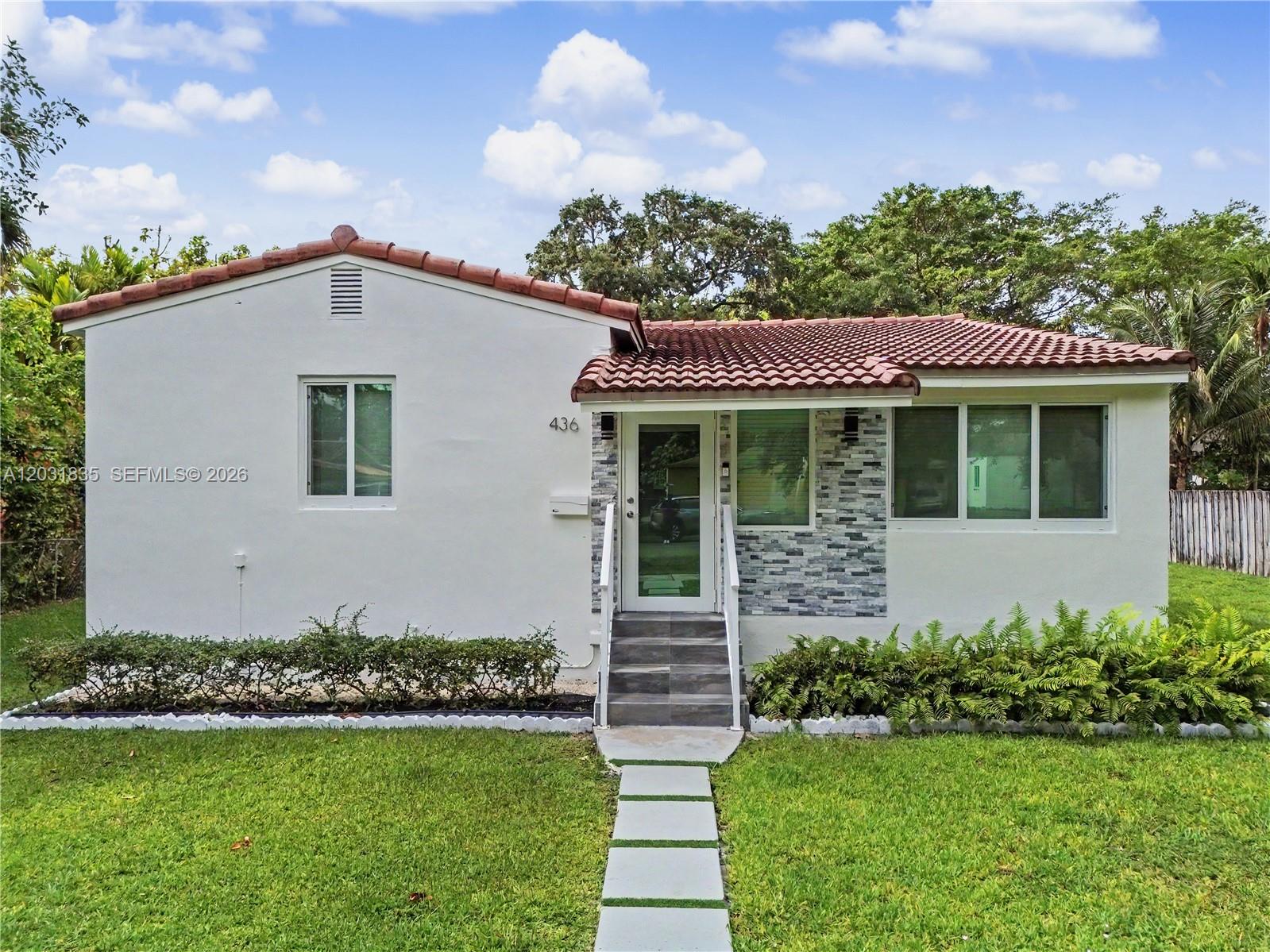 A white house with a red tile roof and stone accents on the front facade — 436 Lark Ave, Miami Springs FL 33166, MIAMI SPRINGS, FL