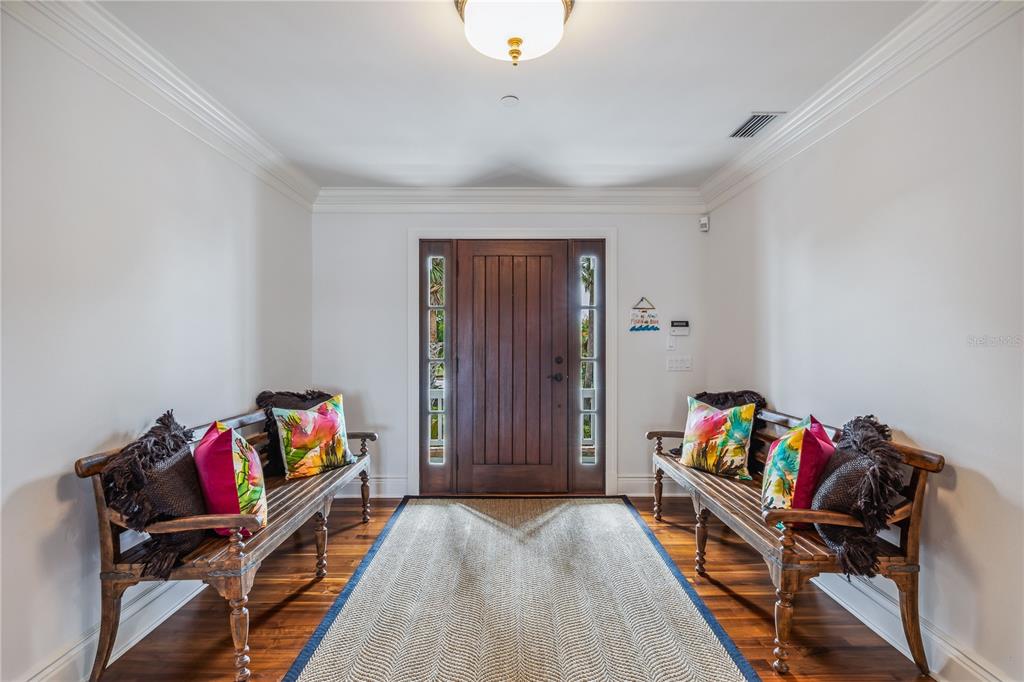 An entryway features a wooden door, two wooden benches, and a central rug — 13310 ANGLERS WAY, PLACIDA, FL