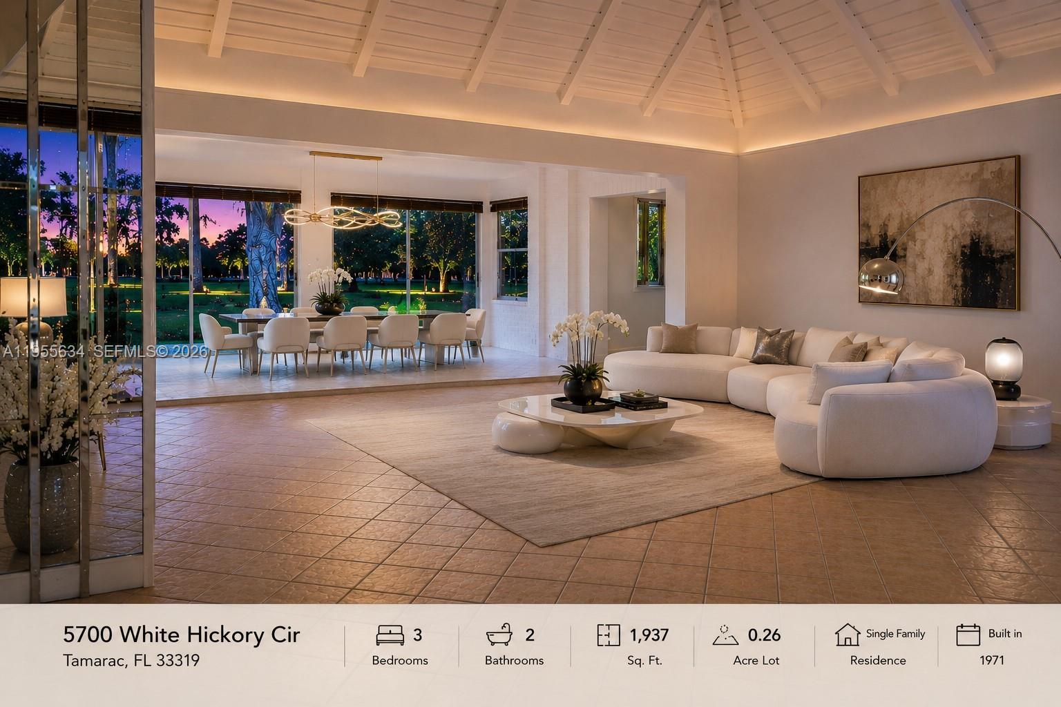 A spacious living room features a vaulted ceiling, tiled floors, and a large curved sofa — 5700 White Hickory Cir, Tamarac FL 33319, TAMARAC, FL