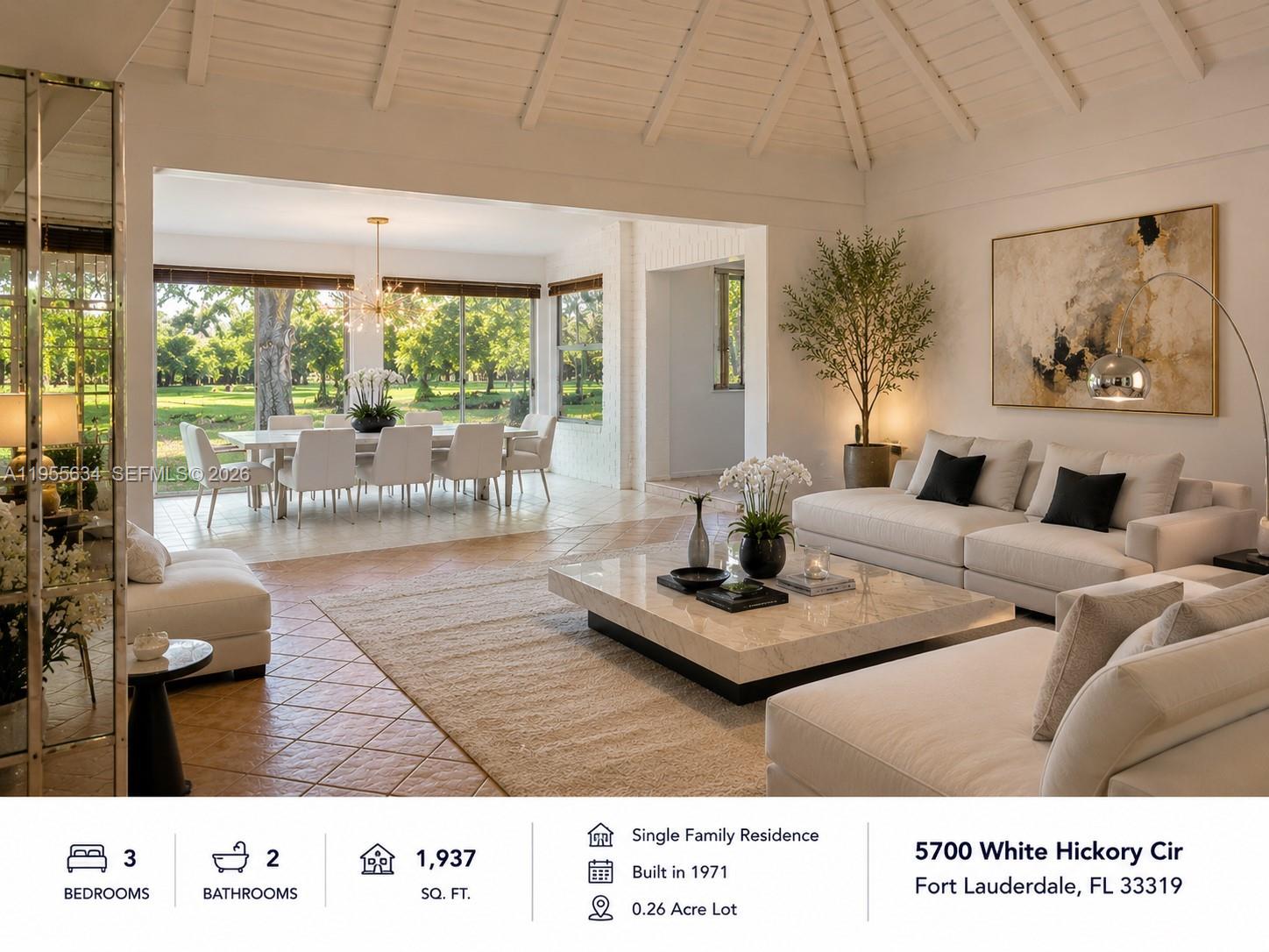 A bright living room features a vaulted ceiling, tile floors, and a view of trees — 5700 White Hickory Cir, Tamarac FL 33319, TAMARAC, FL