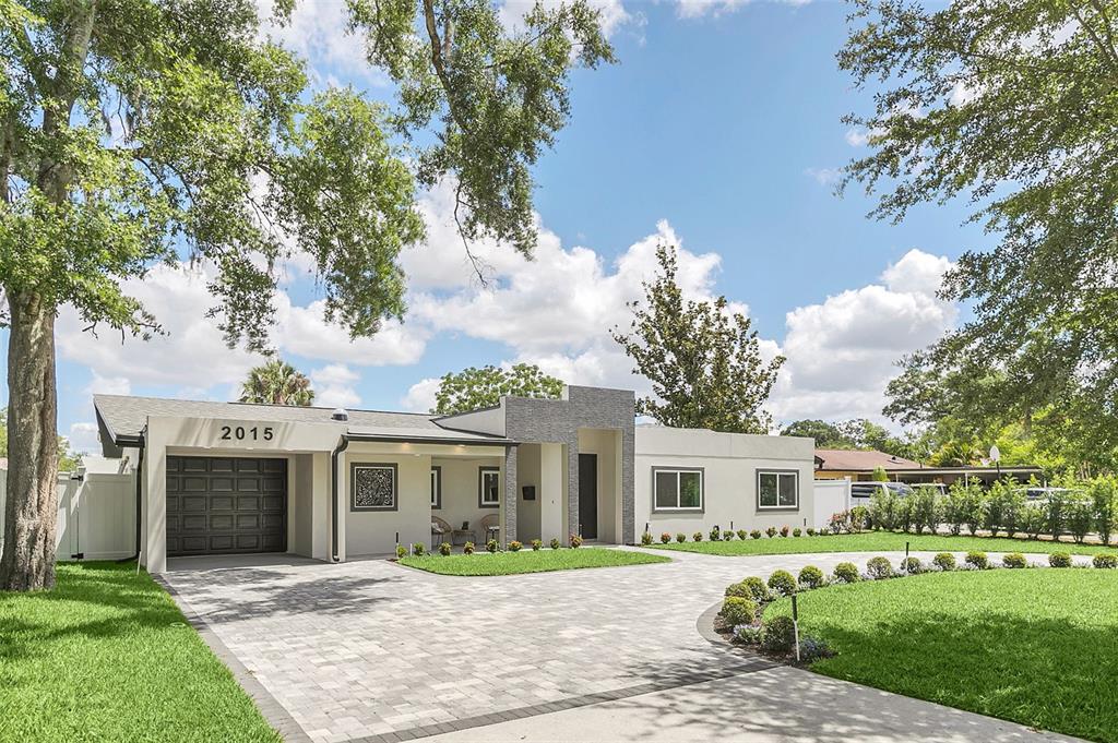 A modern single-story house with a paved driveway, gray stone accents, and a garage — 2015 SUMMERFIELD ROAD, WINTER PARK, FL