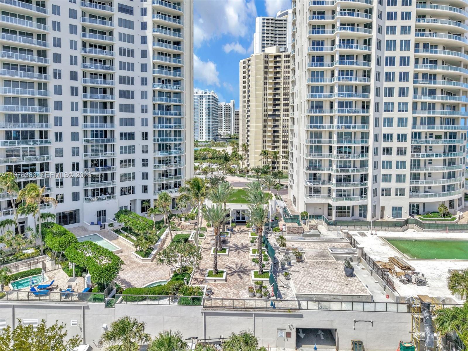 An elevated view shows two high-rise residential towers flanking a landscaped courtyard with palm trees — 2700 N Ocean Drive # 902B, Singer Island FL 33404, SINGER ISLAND, FL