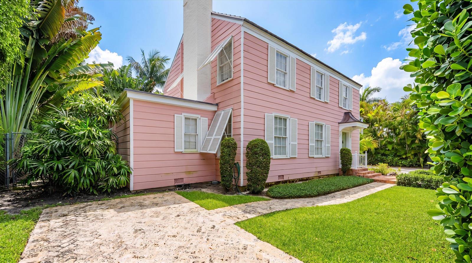A two-story pink house with white trim, a stone walkway, and lush tropical landscaping — 258 Pendleton Avenue, Palm Beach FL 33480, PALM BEACH, FL