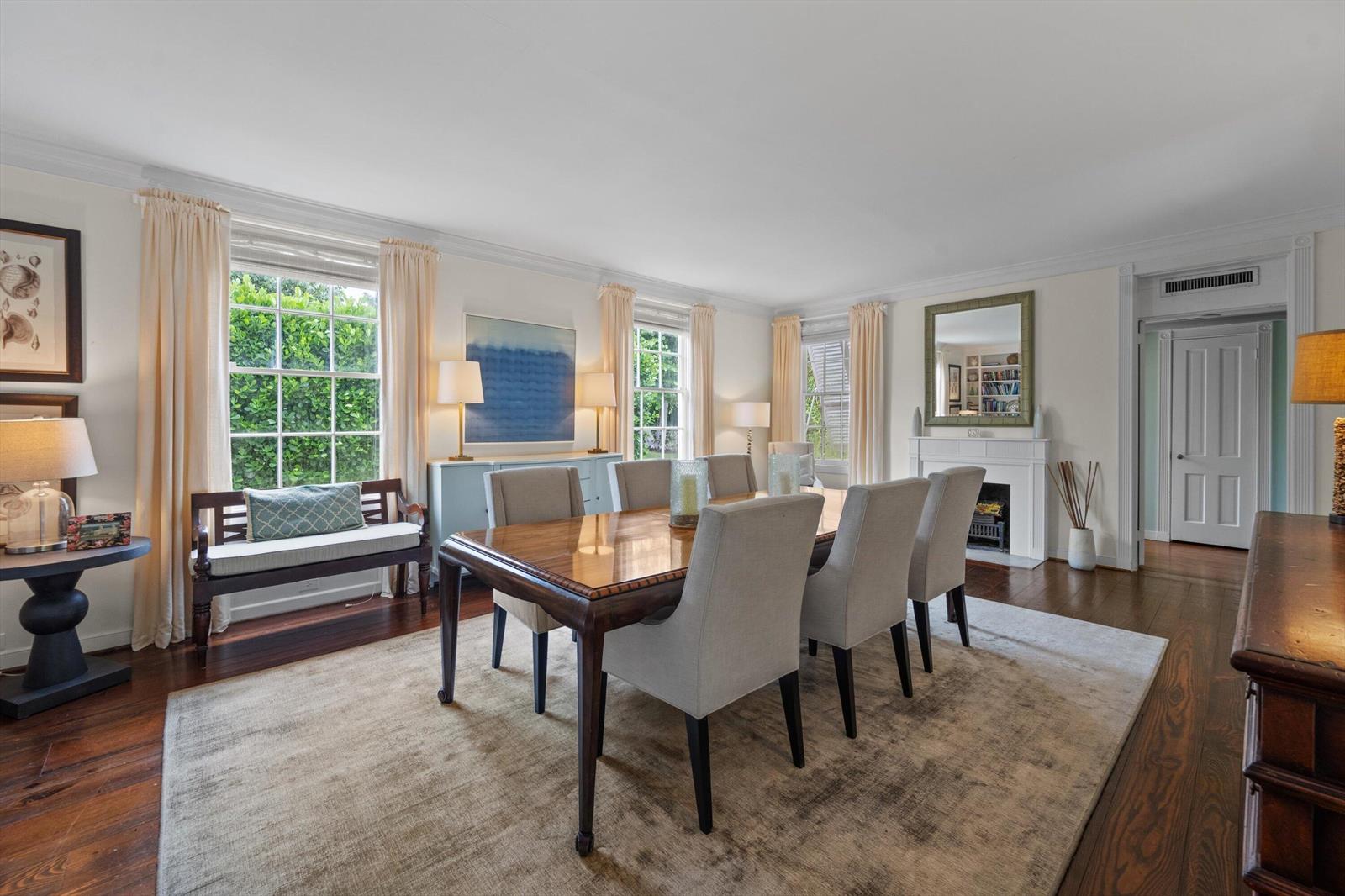 A formal dining room features a wooden table, upholstered chairs, a fireplace, and hardwood floors — 258 Pendleton Avenue, Palm Beach FL 33480, PALM BEACH, FL
