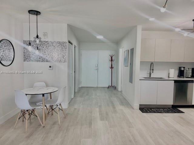 A dining area with a small table and chairs sits next to a modern kitchen — 19380 NE 26th Ave # 304, Miami FL 33180, MIAMI, FL