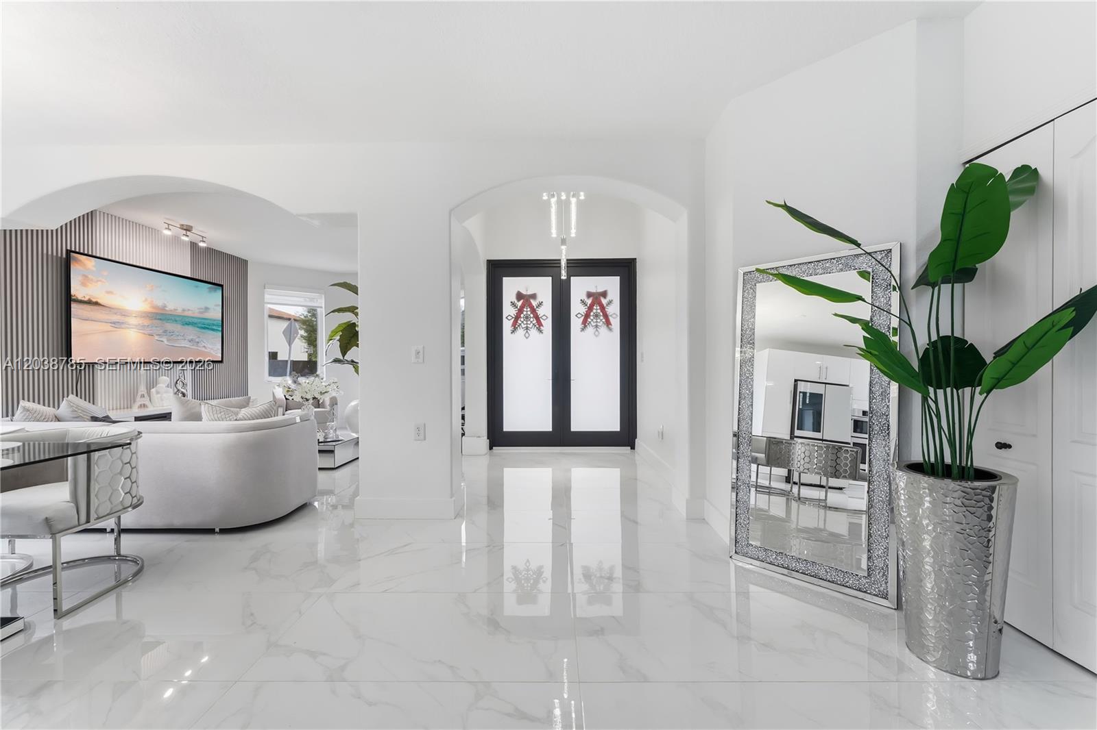 A bright entryway features white marble floors, a large floor mirror, and double front doors — 14452 SW 10th St, Miami FL 33184, MIAMI, FL