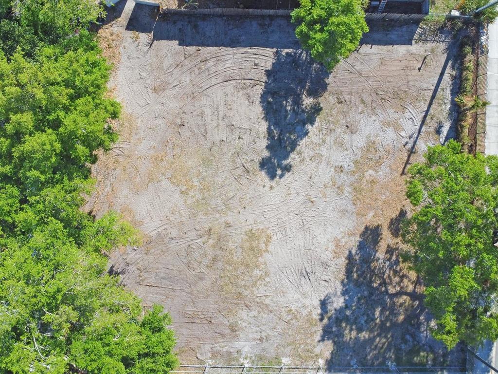 An aerial view of a cleared, vacant rectangular lot surrounded by trees and fencing — 0 DONEGAN, KISSIMMEE, FL