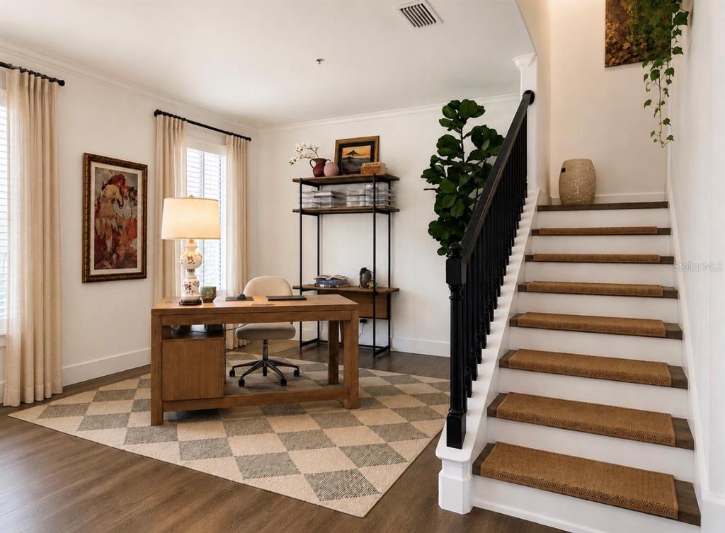 A home office features a wooden desk, a checkered rug, and a staircase with runners — 1152 LAKE BALDWIN LANE, ORLANDO, FL