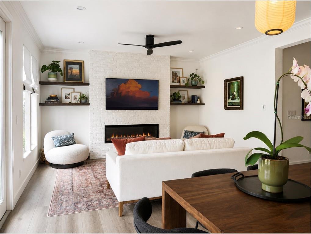 A modern kitchen features white cabinets, black countertops, stainless steel appliances, and a small island — 1152 LAKE BALDWIN LANE, ORLANDO, FL