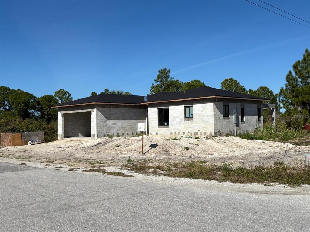 A single-story house under construction with concrete block walls and a dark roof — 2917 22ND STREET W, LEHIGH ACRES, FL