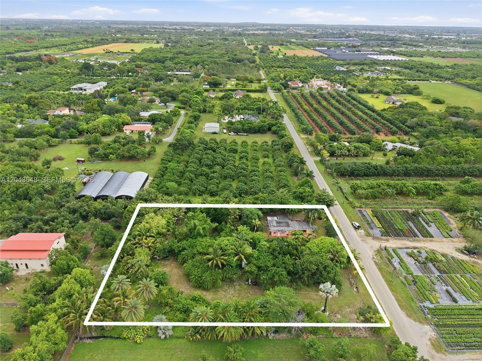 An aerial view shows a rectangular property lot containing a house surrounded by dense trees — 15401 SW 240th St, Homestead FL 33032, HOMESTEAD, FL