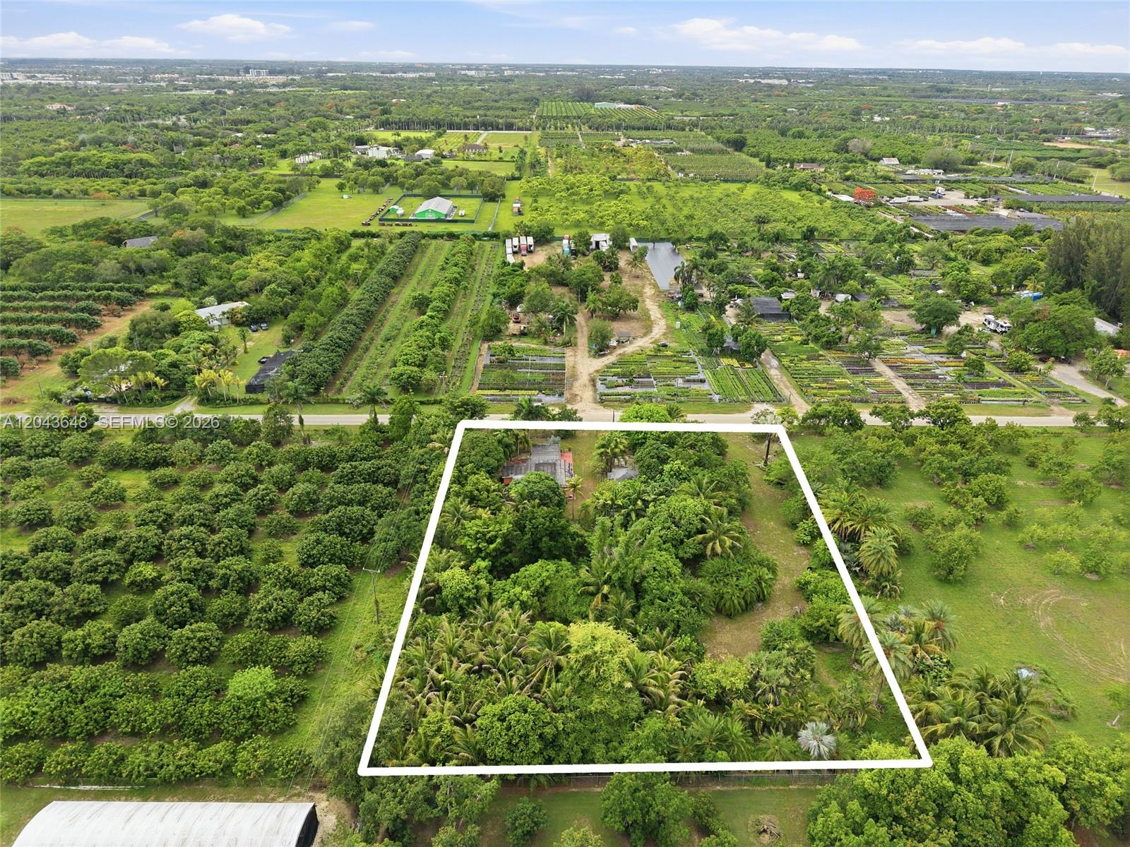 An aerial view shows a rectangular property outlined in white, surrounded by dense green vegetation — 15401 SW 240th St, Homestead FL 33032, HOMESTEAD, FL