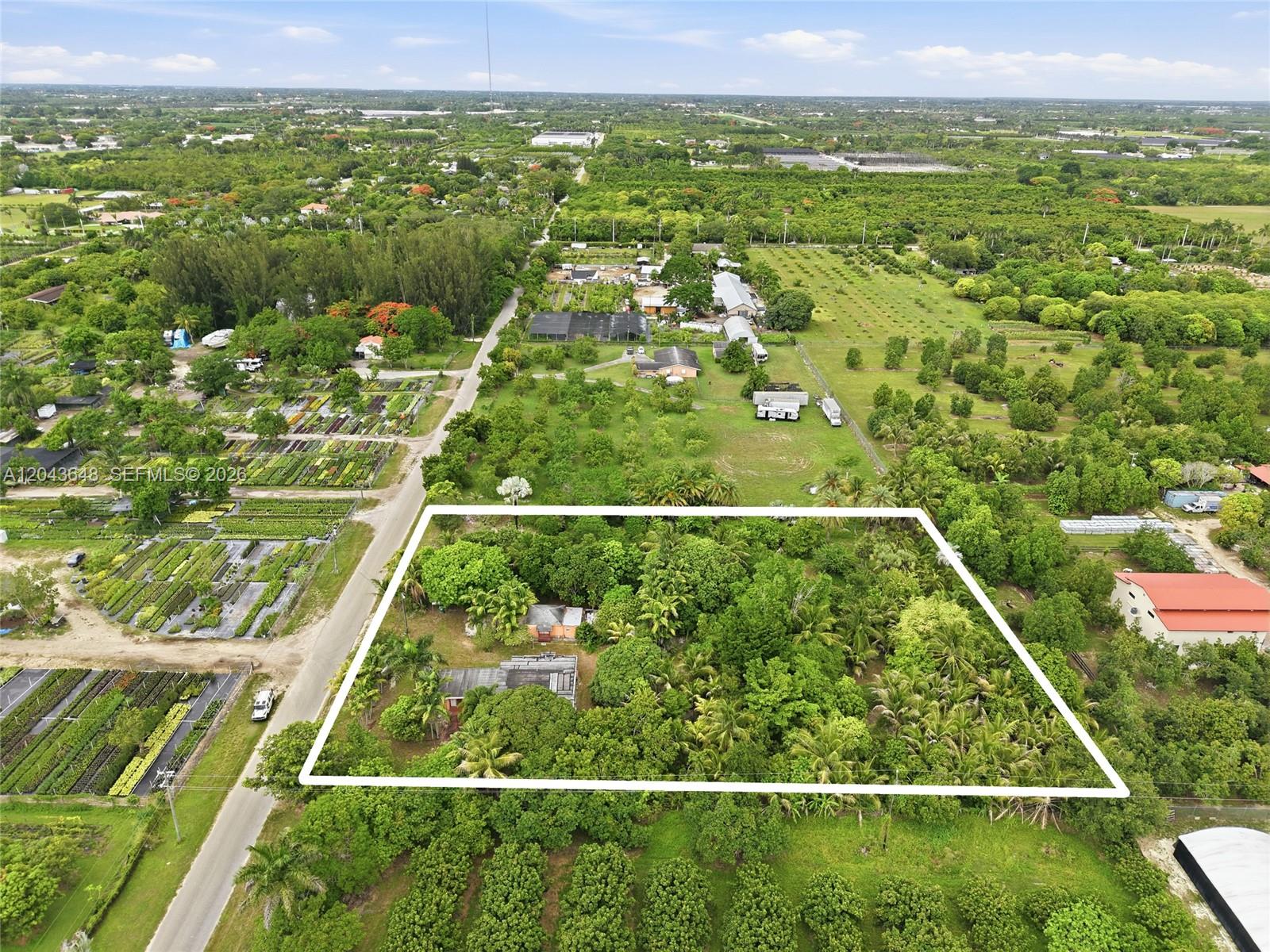An aerial view shows a rectangular lot with a house surrounded by dense trees — 15401 SW 240th St, Homestead FL 33032, HOMESTEAD, FL