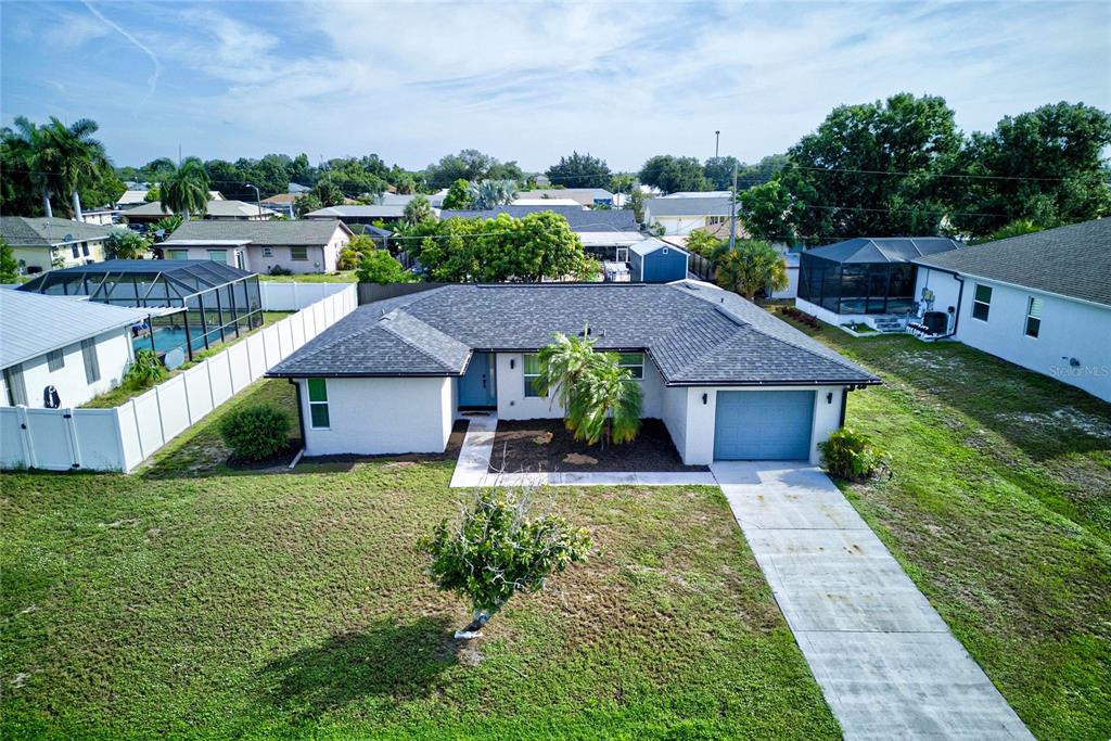 An aerial view shows a single-story house with a gray roof and a red pin — 27072 HILLSHIRE LANE, PUNTA GORDA, FL