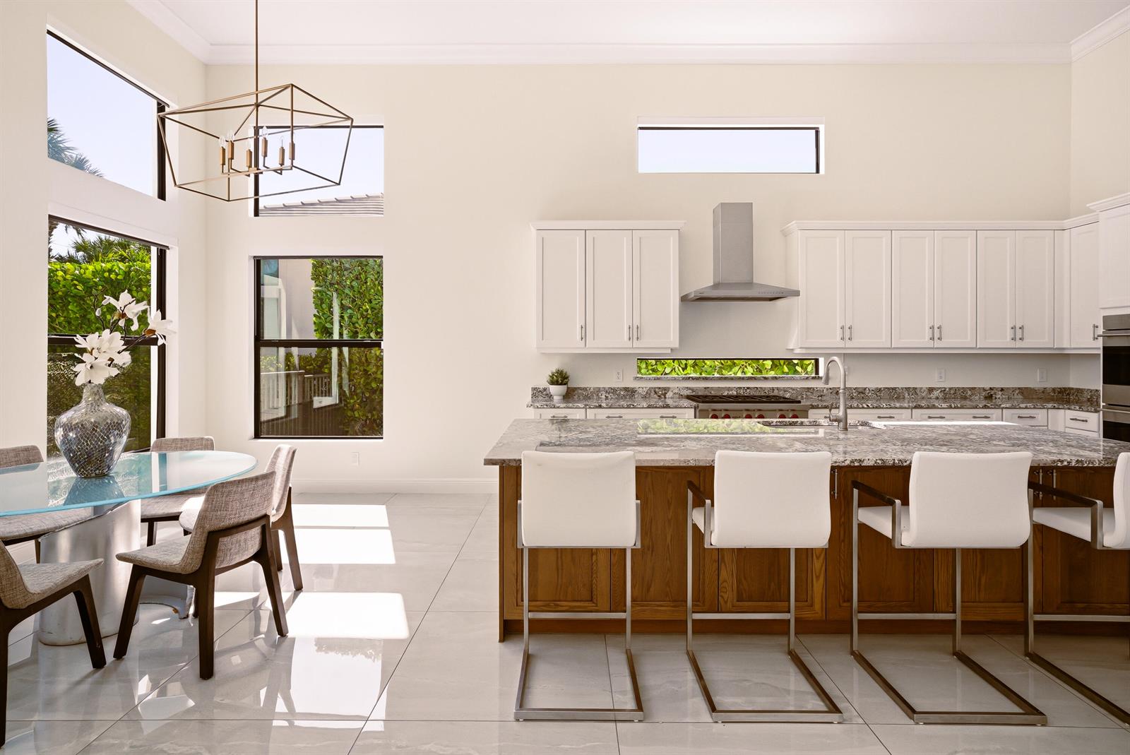 A two-story house with a stone-accented facade, two garage doors, and a front balcony — 2630 NW 69th Street, Boca Raton FL 33496, BOCA RATON, FL