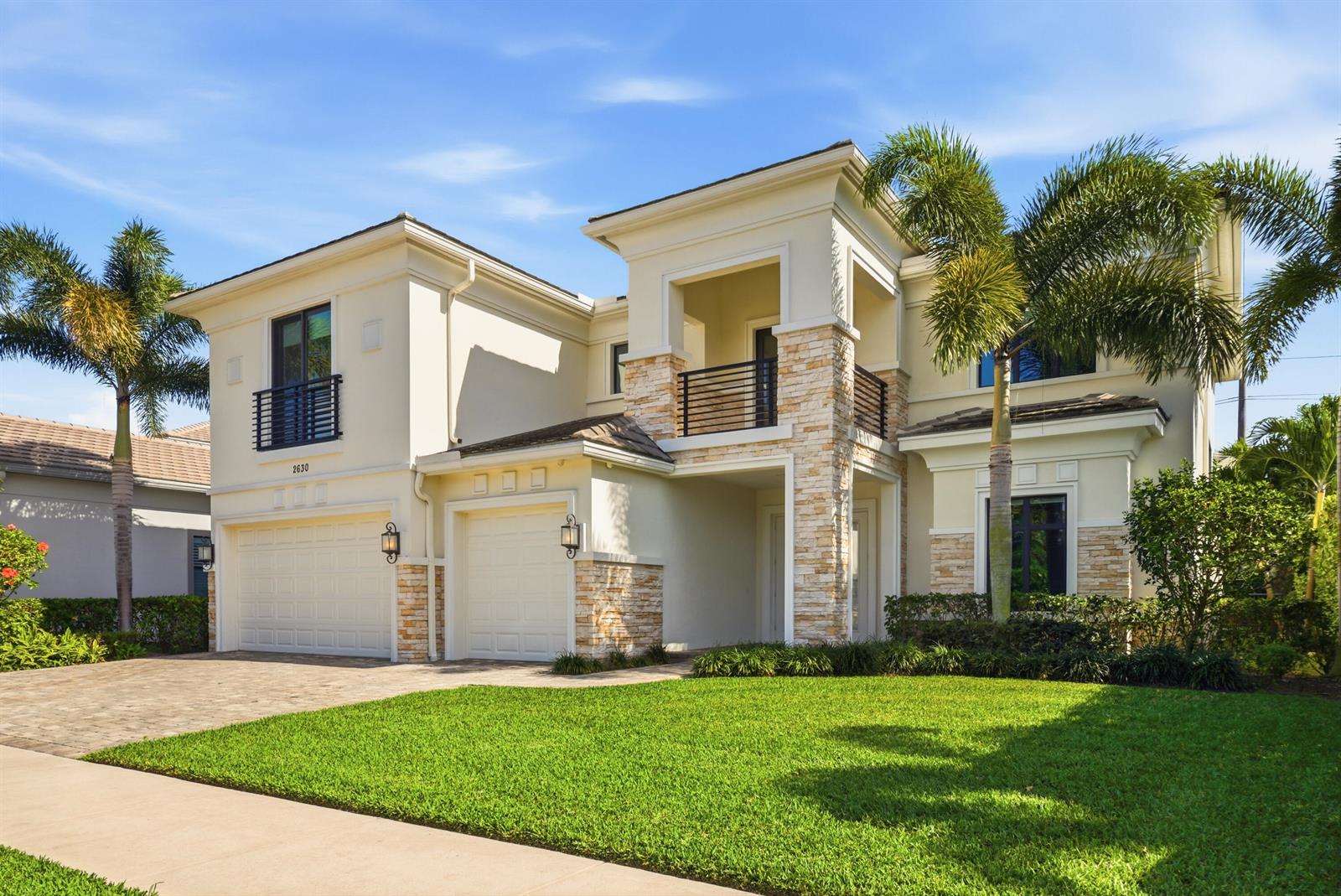 A two-story house with a paved driveway, a three-car garage, and palm trees — 2630 NW 69th Street, Boca Raton FL 33496, BOCA RATON, FL
