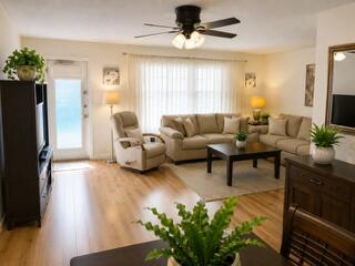 A kitchen with wood cabinets, white appliances, a ceiling fan, and light-colored countertops — 108 Greenbrier, West Palm Beach FL 33417, WEST PALM BEACH, FL