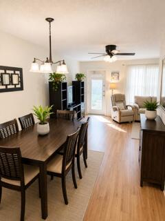 A kitchen features wood cabinets, a white refrigerator, a stainless steel sink, and wood flooring — 108 Greenbrier, West Palm Beach FL 33417, WEST PALM BEACH, FL