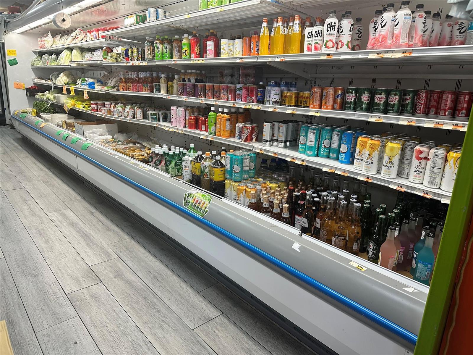A refrigerated display case in a grocery store is stocked with various beverages and produce — 2518 N State Rd, Hollywood FL 33021, HOLLYWOOD, FL