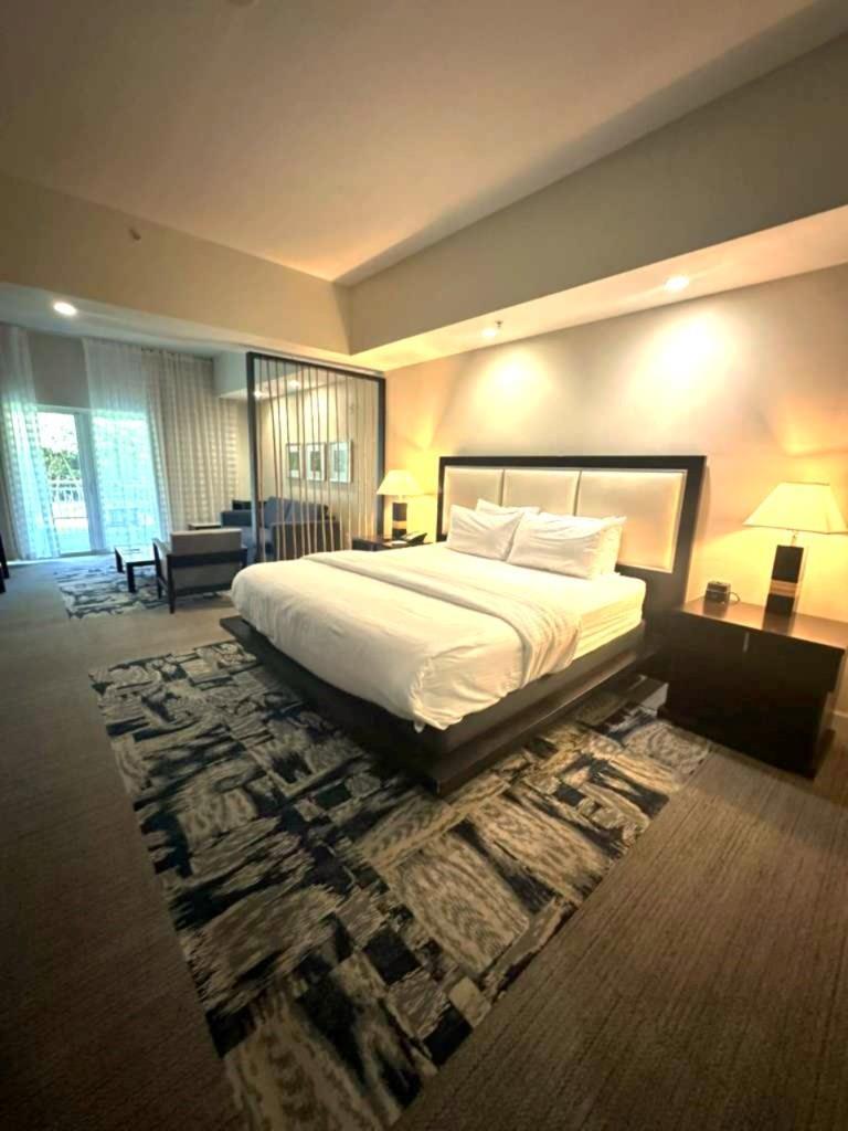 A hotel room features a king bed, a patterned area rug, and a seating area — 5300 NW 87th Avenue # 706, Miami FL 33178, MIAMI, FL