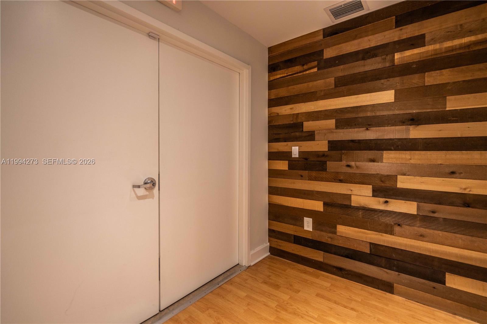 A room features a white double door next to a wall with horizontal wood paneling — 3119 Coral Way # 200, Miami FL 33145, MIAMI, FL