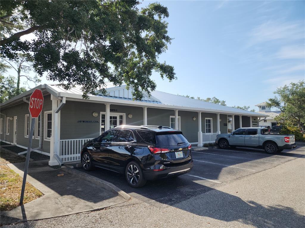 A single-story commercial building with a metal roof and a parking lot in front — 17801 MURDOCK CIRCLE UNIT C, PORT CHARLOTTE, FL