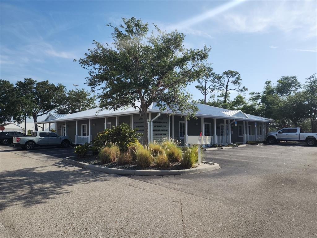 A single-story commercial building with a metal roof and a parking lot in front — 17801 MURDOCK CIRCLE UNIT C, PORT CHARLOTTE, FL