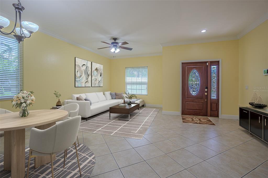 A living and dining area features yellow walls, tile flooring, and a wooden front door — 20520 SULTANA COURT, TAMPA, FL