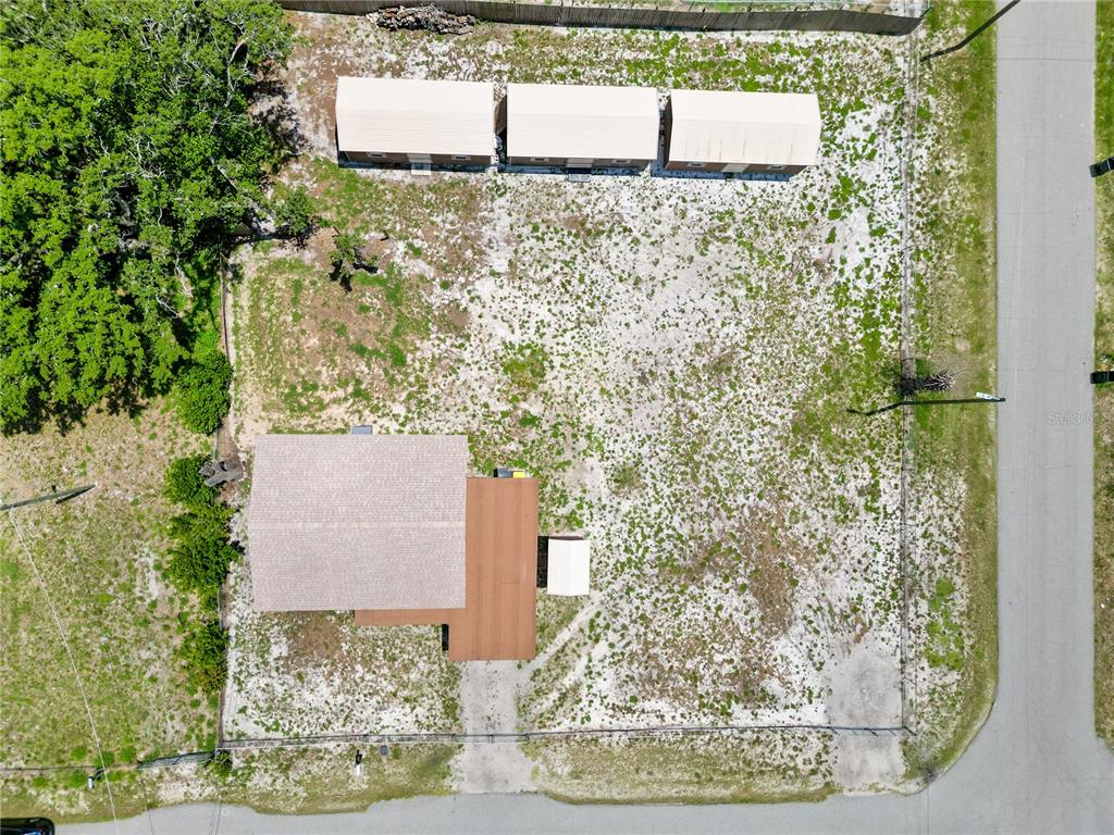 An aerial view shows a house, three sheds, and a large yard on a corner lot — 404 ARMOUR AVENUE, AUBURNDALE, FL