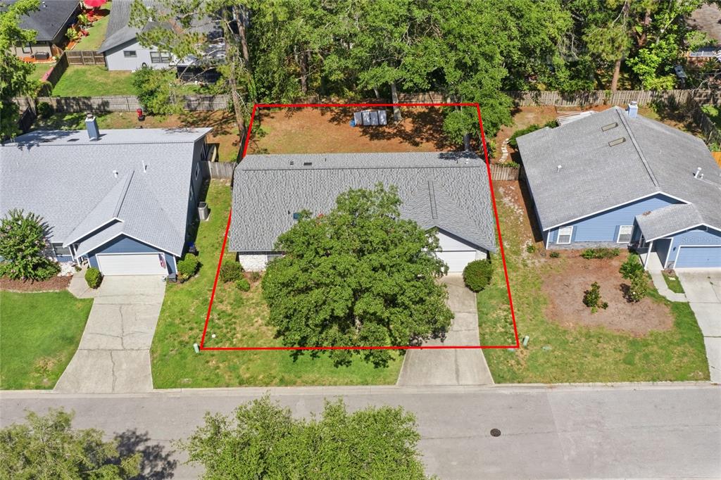 An aerial view shows a single-story house with a large tree in the front yard — 6438 NW 37TH TERRACE, GAINESVILLE, FL