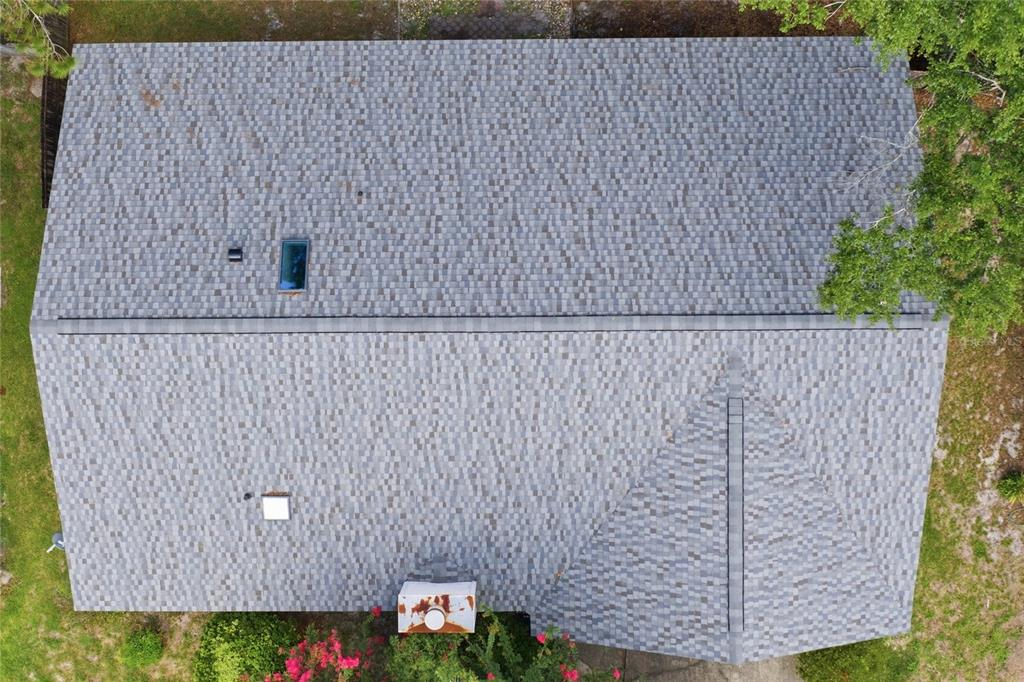 An aerial view shows a gray shingled roof with a chimney, skylights, and vents — 6438 NW 37TH TERRACE, GAINESVILLE, FL