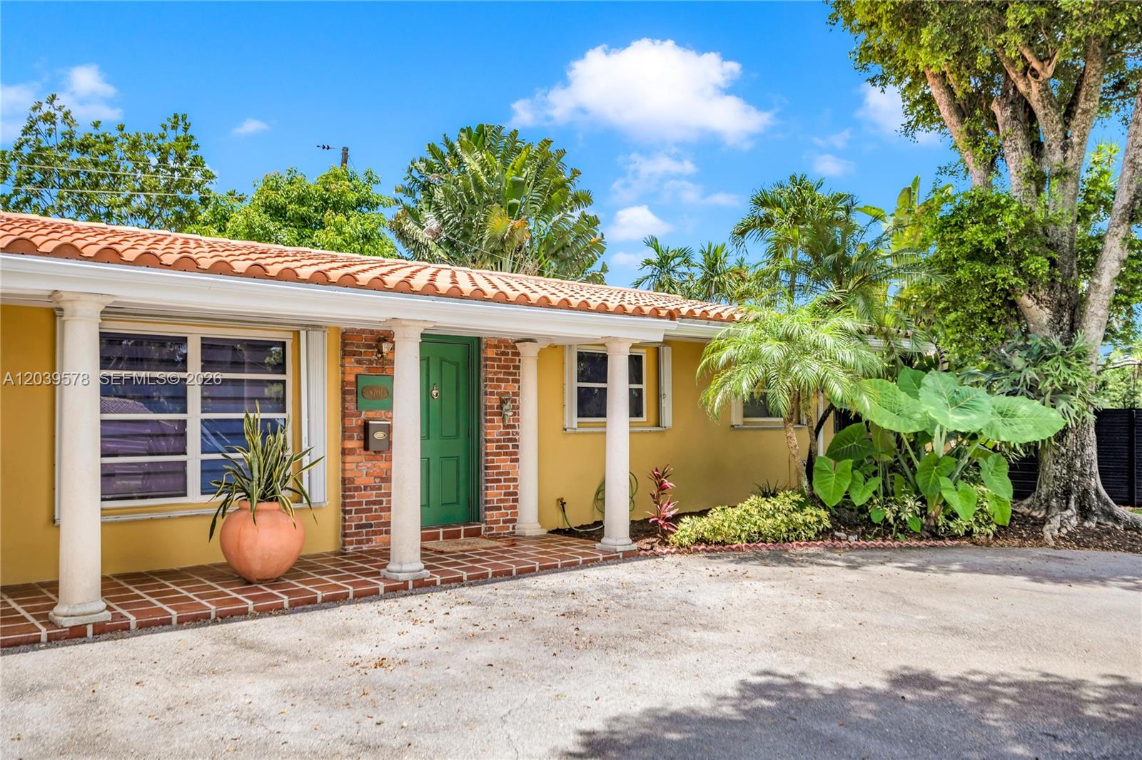 A yellow house with a tiled roof, white columns, and a green front door — 8701 SW 87th Ct, Miami FL 33173, MIAMI, FL