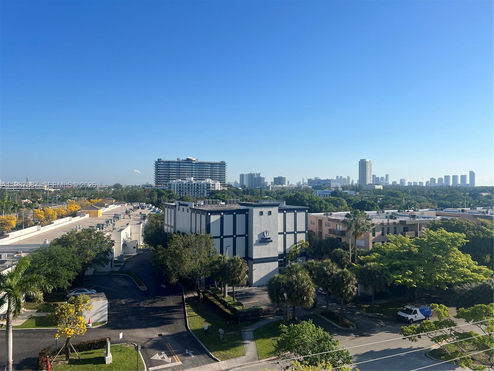 An elevated view shows a storage facility building surrounded by trees, parking lots, and city buildings — 13499 Biscayne Blvd # 613, North Miami FL 33181, NORTH MIAMI, FL