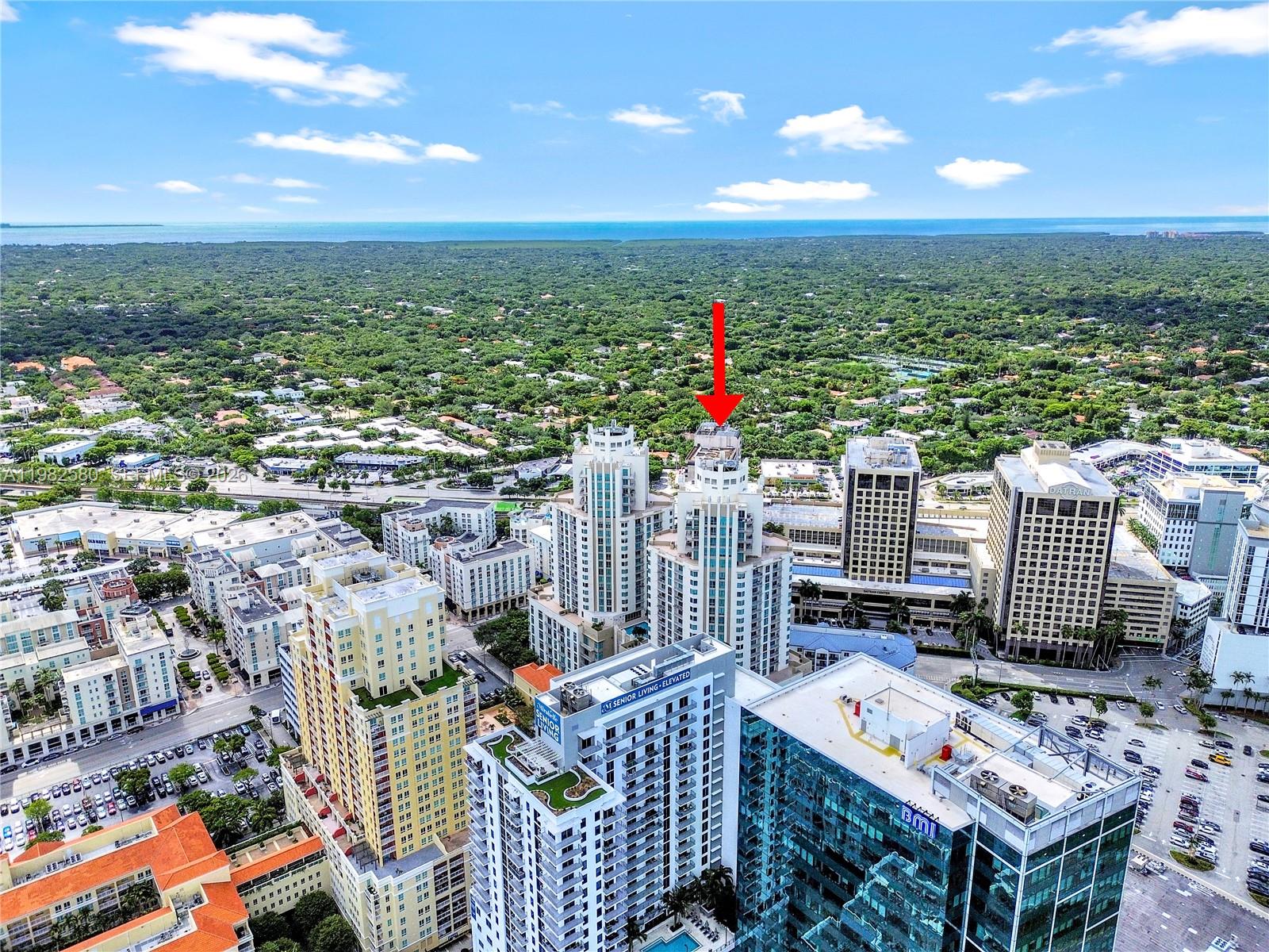An aerial view shows a high-rise building marked with a red arrow in Miami — 9055 SW 73rd Ct # 1104, Miami FL 33156, MIAMI, FL