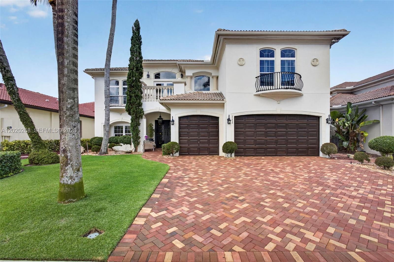 A two-story Mediterranean-style house features a brick paver driveway, a three-car garage, and balconies — 111 Abondance Dr, Palm Beach Gardens FL 33410, PALM BEACH GARDENS, FL