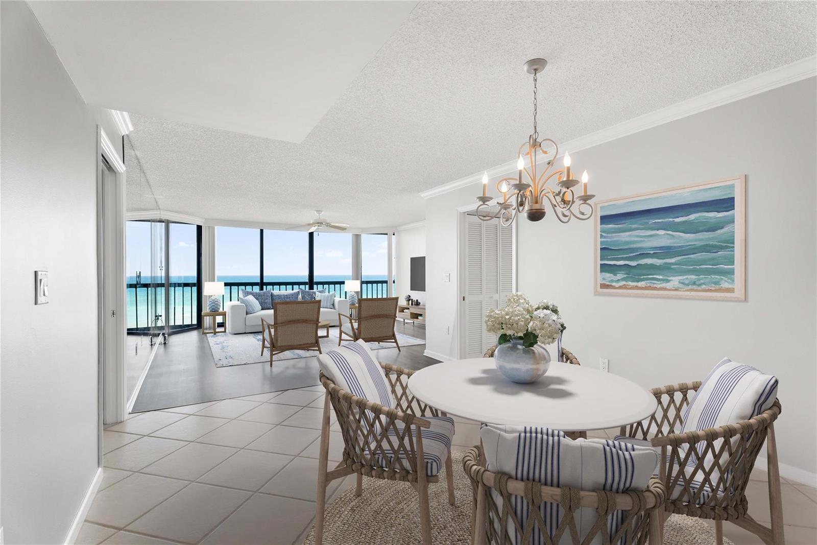 A dining area with a round table and a living room overlooking the ocean — 8800 S Ocean Drive # 505, Jensen Beach FL 34957, JENSEN BEACH, FL