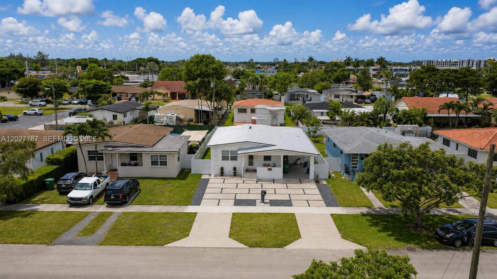 An aerial view shows a white house with a paved driveway between two neighboring homes — 6748 SW 38th St, Miami FL 33155, MIAMI, FL