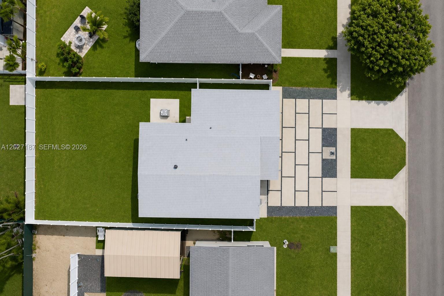 An aerial view shows a house with a white roof, a large lawn, and a driveway — 6748 SW 38th St, Miami FL 33155, MIAMI, FL