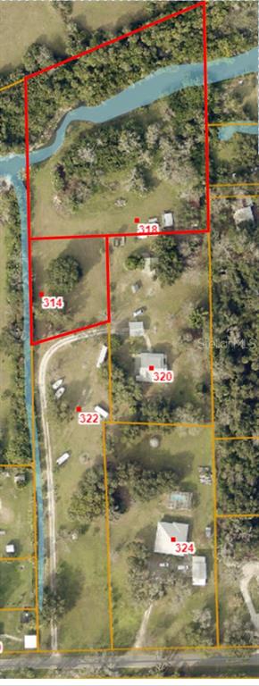 This is an aerial map showing multiple adjacent land parcels with houses and outbuildings — 318 PALM AVENUE, OAK HILL, FL
