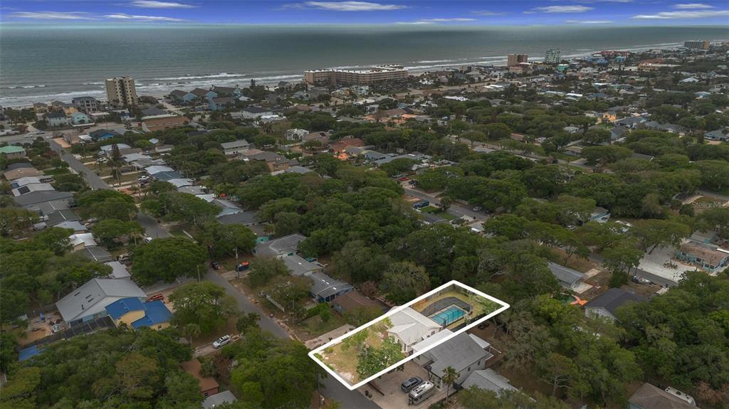 An aerial view shows a house with a pool and a large yard near the coast — 805 E 11TH AVENUE, NEW SMYRNA BEACH, FL