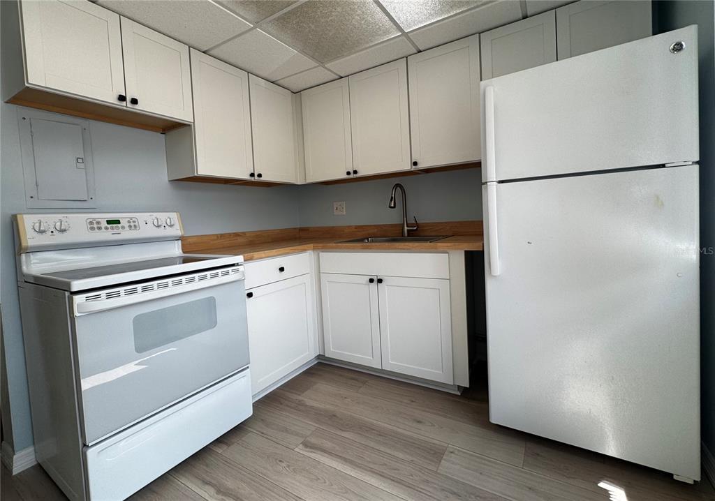A room features white louvered closet doors, built-in shelving, a water heater, and an HVAC unit — 6700 1ST AVENUE S UNIT 103, ST PETERSBURG, FL