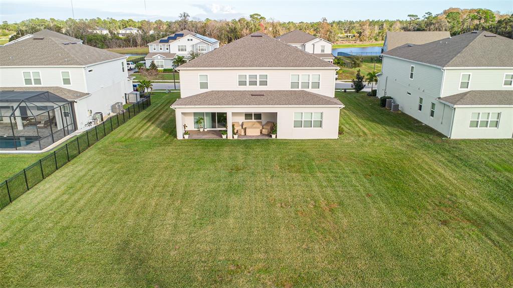 An aerial view shows the backyard and rear exterior of a two-story suburban house — 2206 WEATHERLY WAY, ORLANDO, FL