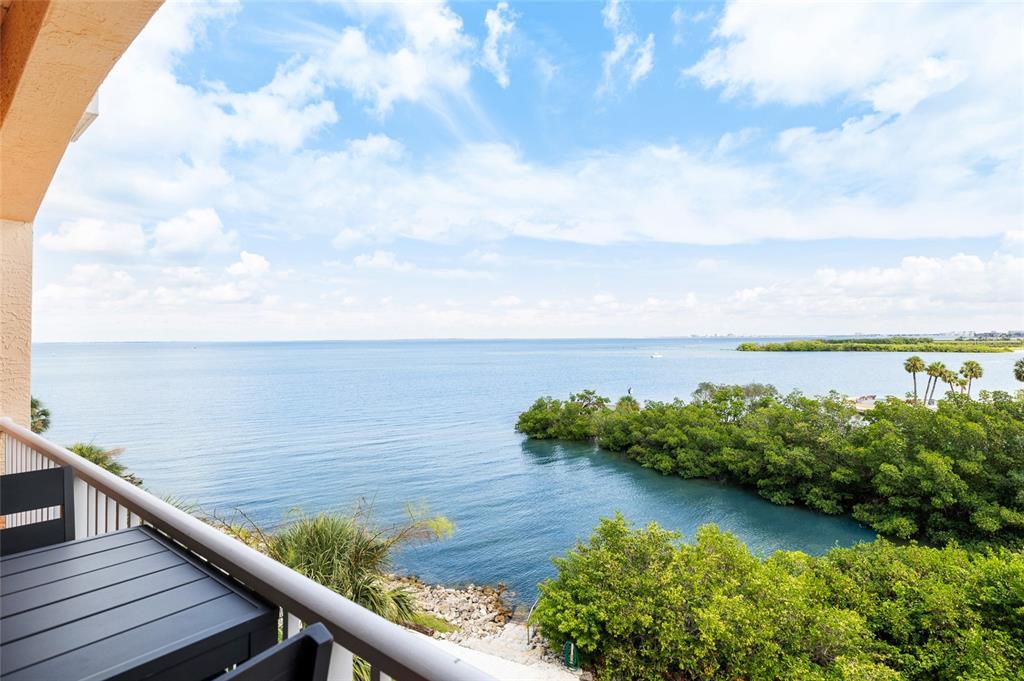 A balcony overlooks a calm bay with lush green mangroves and a distant shoreline — 5000 CULBREATH KEY WAY UNIT 9316, TAMPA, FL