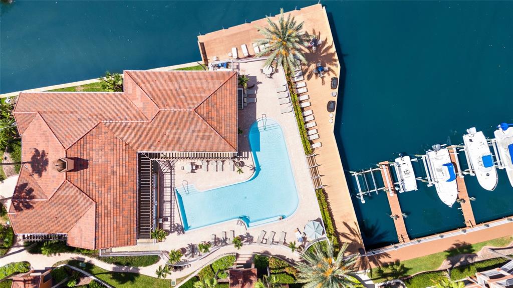 An aerial view shows a house with a tiled roof, a swimming pool, and boat slips — 5000 CULBREATH KEY WAY UNIT 9316, TAMPA, FL