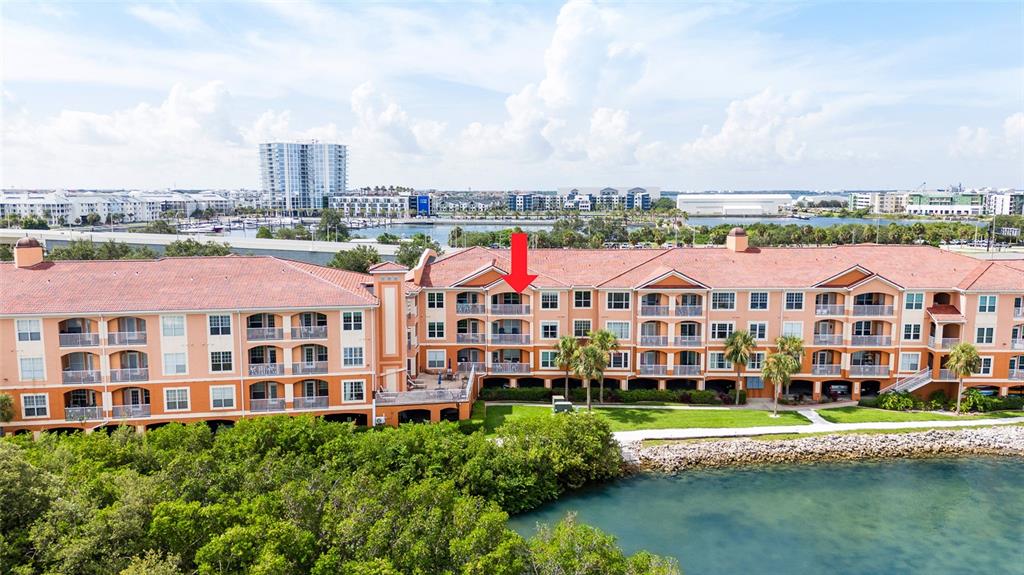 An exterior view of a multi-story apartment building with balconies overlooking a waterfront area — 5000 CULBREATH KEY WAY UNIT 9316, TAMPA, FL