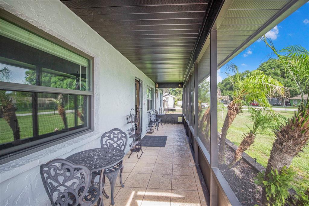 A living room features a grey sofa, a front door, and a wooden console table — 2426 VIEW WAY, LAKELAND, FL