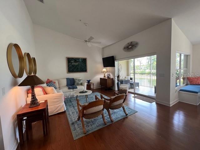 A living room features a white sofa, two armchairs, a rug, and a sliding glass door — 5270 HYLAND HILLS AVENUE UNIT 1724, SARASOTA, FL