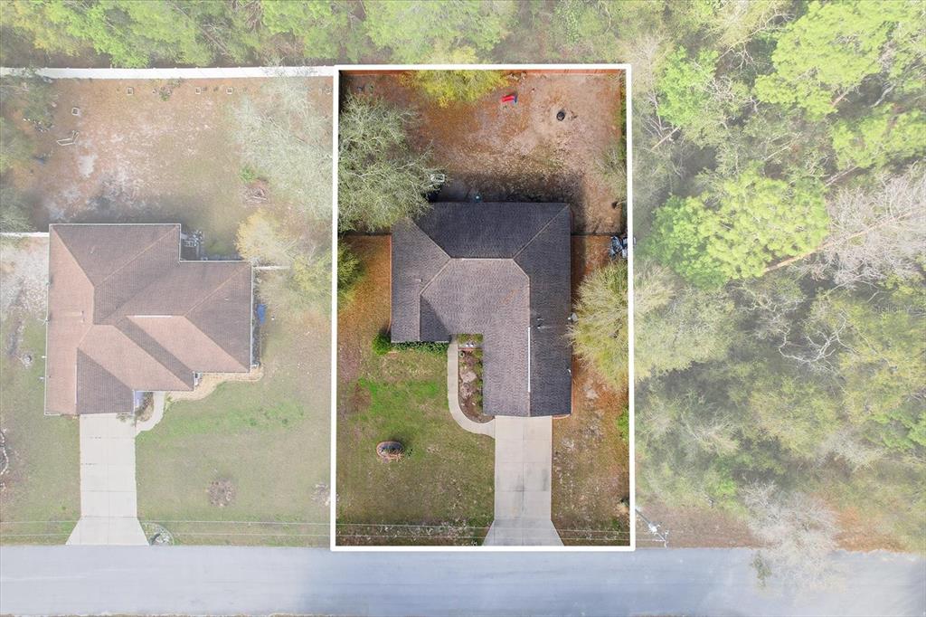 An aerial view shows a single-story house with a dark roof and a concrete driveway — 786 N DUGAN AVENUE, INVERNESS, FL